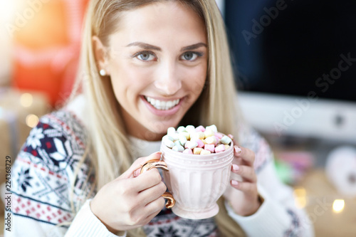 Adult woman relaxing at home during Christmas time