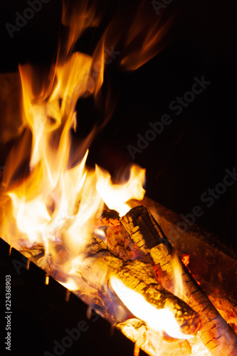 Bright burning wood in a camping on a black background