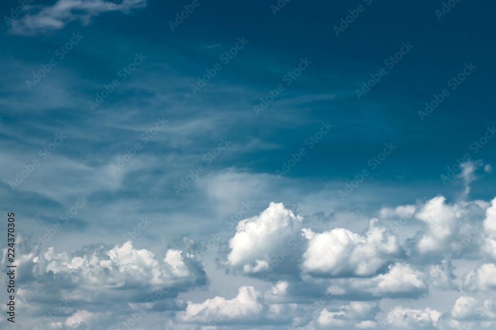 Obraz premium Fantastic, fluffy, white clouds against a blue sky. Rain clouds. The situation in the sky before the storm. copy space