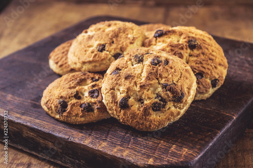 Chocolate chip cookies on wooden board, closeup