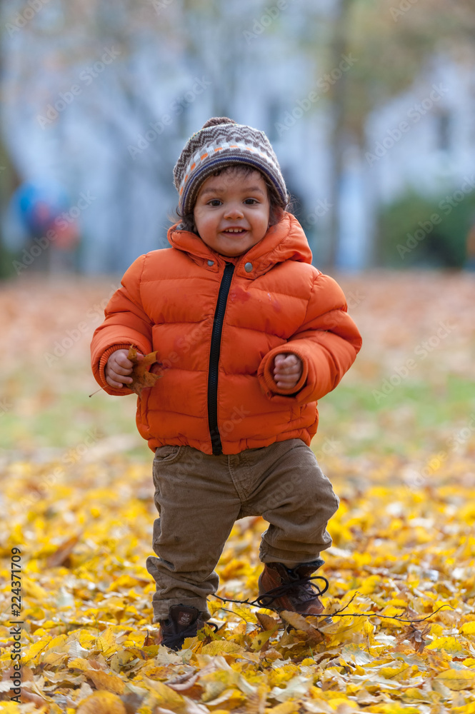 Baby boy running in park in autumn Baby boy running in park in autumn