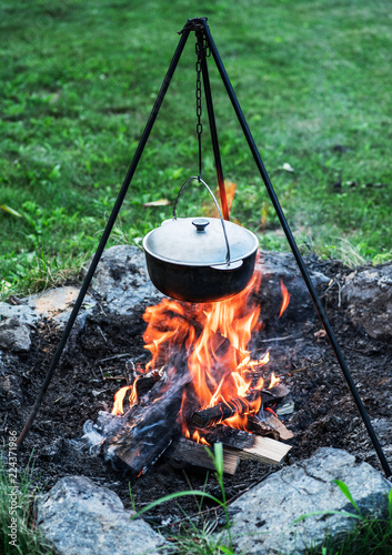 Cauldron over the fire in the open-air.