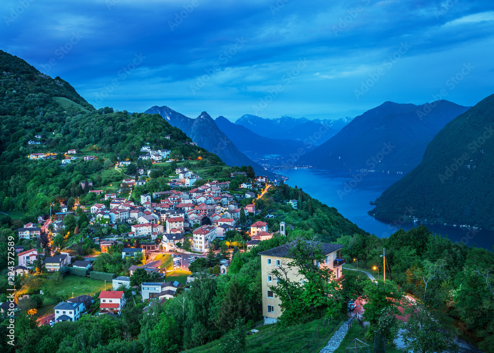 Village of Brè. Switzerland, May 11, 2018. View from Monte Brè Mountain of night village and range of mountains. Village of Brè. Switzerland, May 11, 2018. View from Monte Brè Mountain of night village and range of mountains.