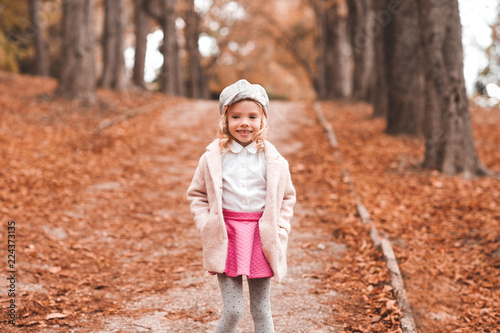 Smiling kid girl 4-5 year old wearing autumn walking park. Childhood. © morrowlight