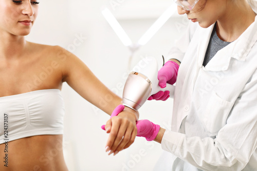Adult woman having laser hair removal in professional beauty salon