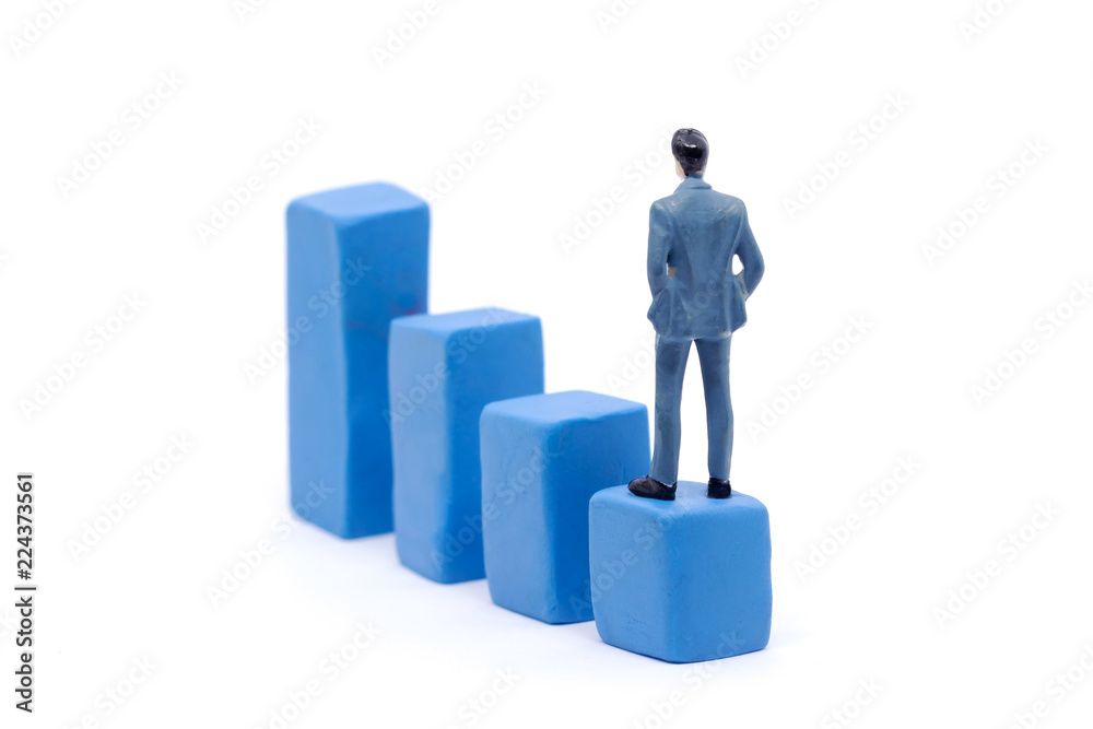 Miniature businessman and graph on white background, Business Growth concept Miniature businessman and graph on white background, Business Growth concept