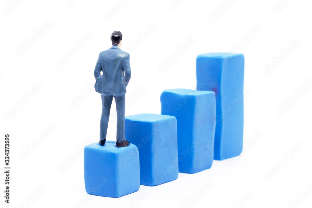 Miniature businessman and graph on white background, Business Growth concept Miniature businessman and graph on white background, Business Growth concept