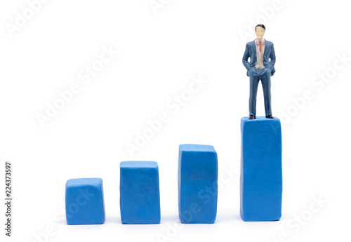 Miniature businessman and graph on white background, Business Growth concept