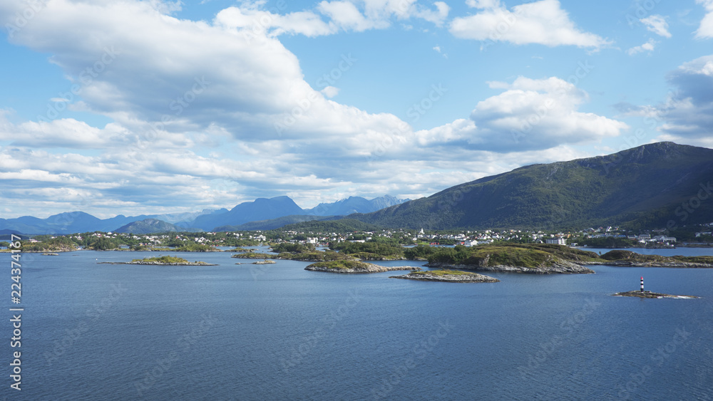Horizontal shot with perspective from fjord, at high, vantage point, of the city of Bergen, unusual landscape with scattered villages, remote islets, solitary houses surrounded by mountains, Norway Horizontal shot with perspective from fjord, at high, vantage point, of the city of Bergen, unusual landscape with scattered villages, remote islets, solitary houses surrounded by mountains, Norway
