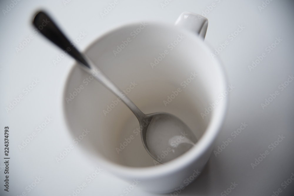 A white cup with a spoon is a top view. Белая чашка с ложкой вид сверху. A white cup with a spoon is a top view. Белая чашка с ложкой вид сверху.