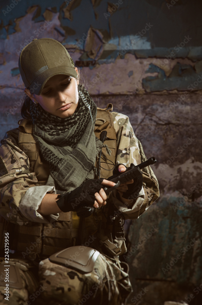 Fototapeta premium the people in uniform with weapons in the ruins