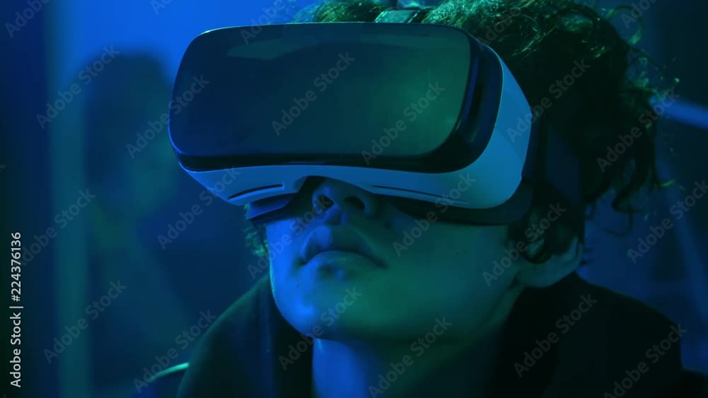 Young man watching video in virtual reality glasses Young man watching video in virtual reality glasses