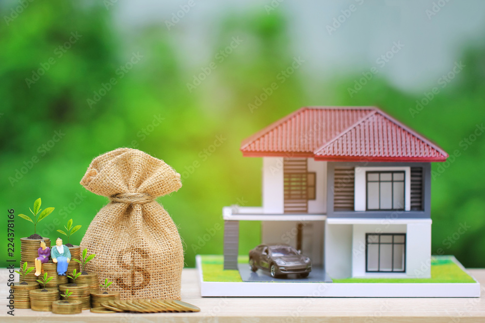 Interest rates, Money bag and plant growing on gold coins money with miniature couple and model house on natural green background, Business investment and real estate concept Interest rates, Money bag and plant growing on gold coins money with miniature couple and model house on natural green background, Business investment and real estate concept