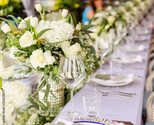 Set table for a white and aqua blue wedding dinner decorated