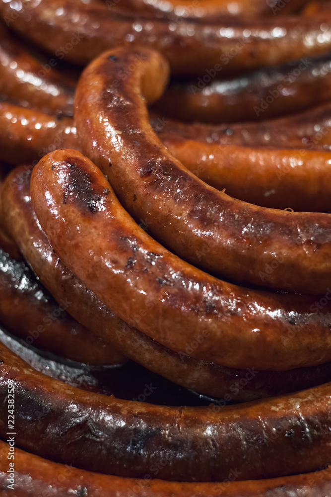 Freshly cooked sausages on a grill Freshly cooked sausages on a grill