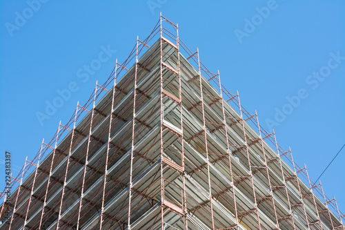 The old building with the scaffolding in Rome, Italy. Concept of safety on work and renovation of the home