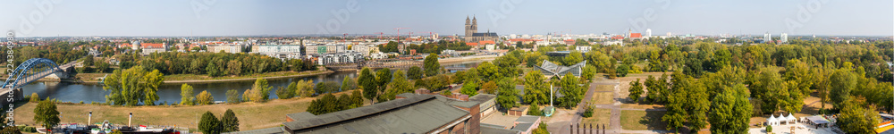 Obraz premium Panorama von Magdeburg mit Elbbrücken, Sternbrücke, Elbe, Dom, Grüne Zitadelle, Jahrtausendturm, Stadthalle, Stadtpark Rotehorn im Sommer von Oben 