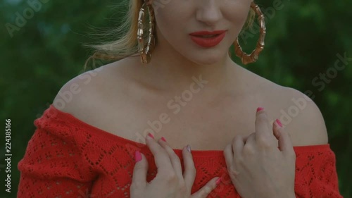 charming red-haired beauty in the desert. woman 30 years of sexually dancing in the sand. eastern motif. an oriental girl in a red cloth and a turban. large gold earrings .Slow motiom photo