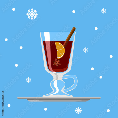 Glass of mulled wine with lemon, cinnamon and star anise on tray