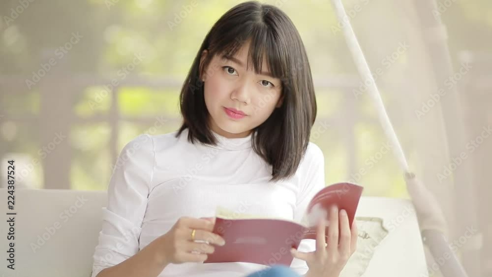 asian younger woman ralaxing reading a book asian younger woman ralaxing reading a book
