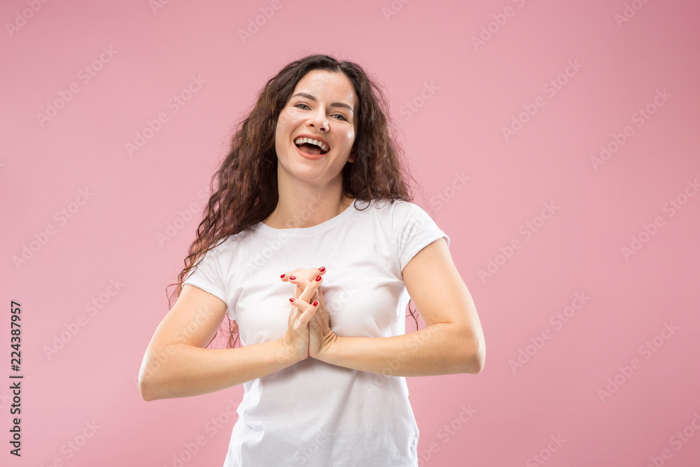 Happy business woman standing and smiling isolated on pink studio background. Beautiful female half-length portrait. Young emotional woman. The human emotions, facial expression concept. Front view. Happy business woman standing and smiling isolated on pink studio background. Beautiful female half-length portrait. Young emotional woman. The human emotions, facial expression concept. Front view.