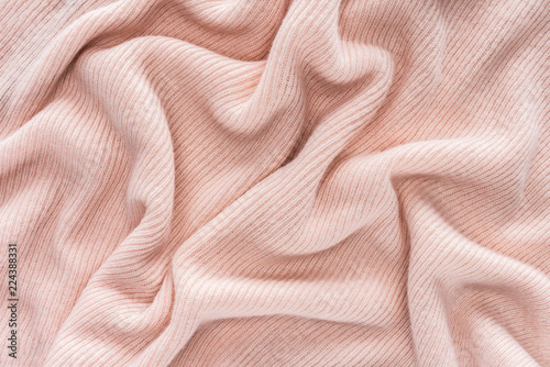 full frame of pink folded woolen fabric background photo