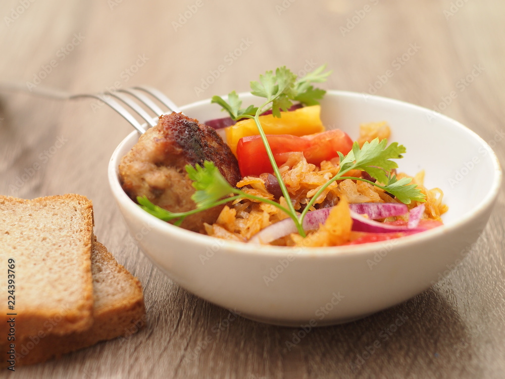 homemade stewed cabbage with salad and chop homemade stewed cabbage with salad and chop