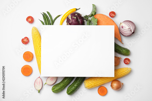 Flat lay composition with fresh vegetables and blank card for text on white background