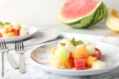 Salad with watermelon and melon on marble table