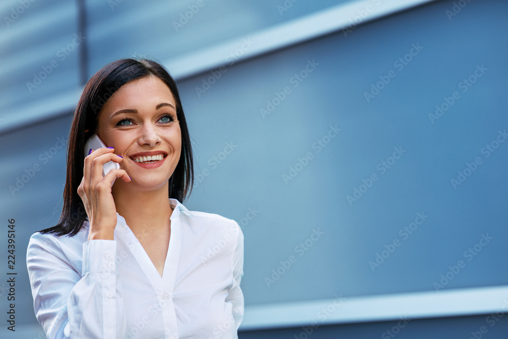 Young business woman talking on the phone outdoor Young business woman talking on the phone outdoor