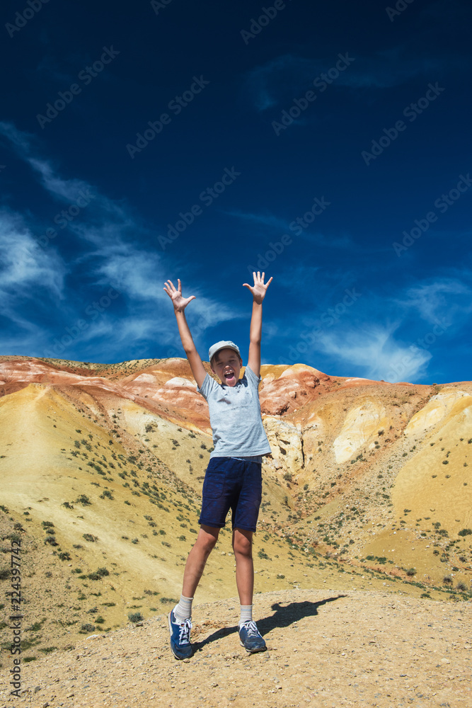Teen boy in valley of Mars landscapes in the Altai Mountains, Kyzyl Chin, Siberia, Russia Teen boy in valley of Mars landscapes in the Altai Mountains, Kyzyl Chin, Siberia, Russia