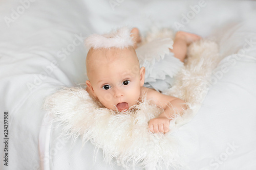 Bright portrait of a sweet little 5 months old baby boy with an open mouth, looking up. copyspace for your text