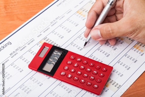 Close-up of a Businessman Analyzing Financial Figures with