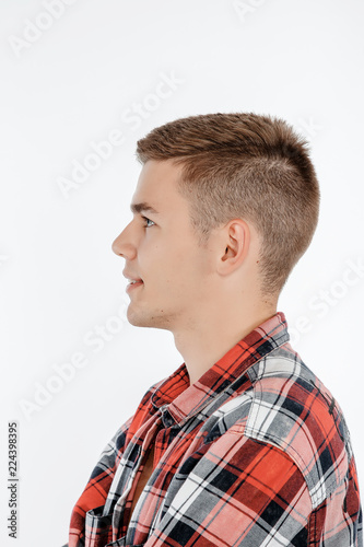 Portrait of a boy in a photo studio. Young Man posing on a white background.