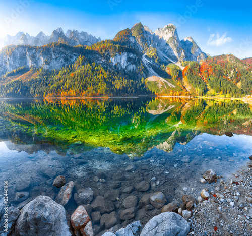 autumn scenery with Dachstein mountain summit reflecting in crystal clear Gosausee mountain lake photo