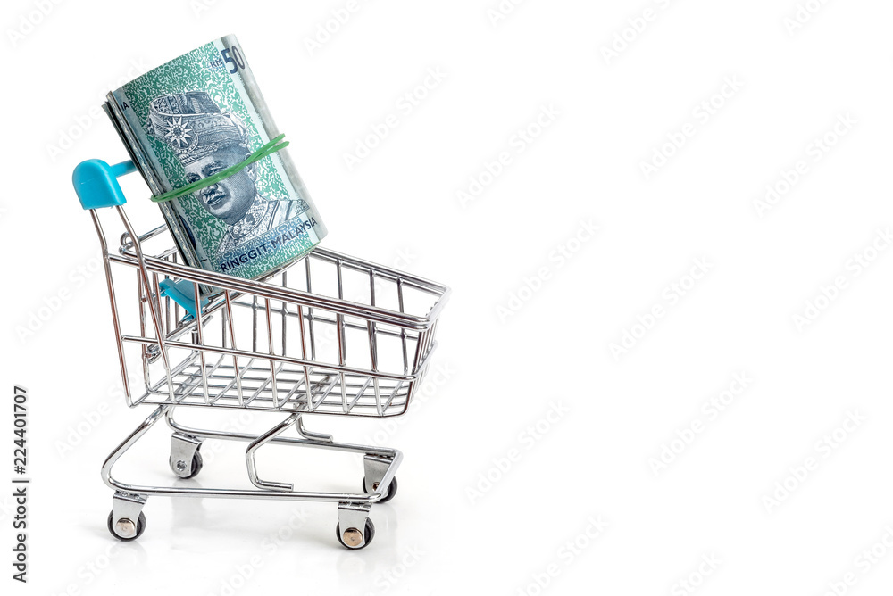 Bundled Malaysian Ringgits in a shopping cart, isolated on white background.