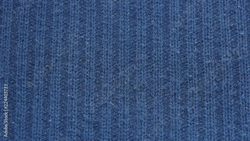 warm blue dark woolen sweater fabric texture background wool close-up.