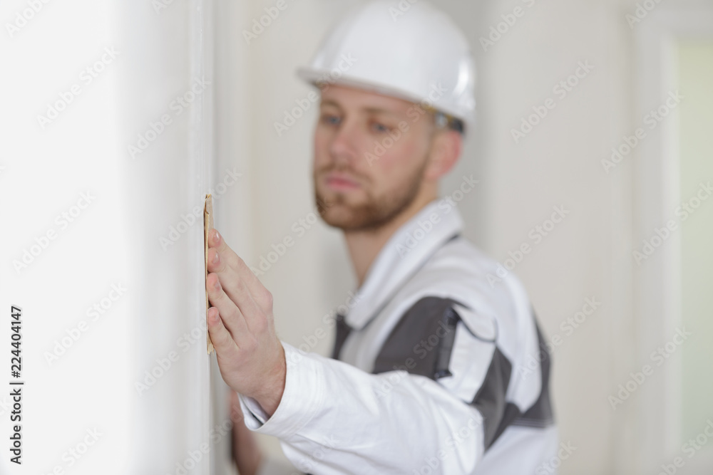 close-up of polishing a wall with sandpaper close-up of polishing a wall with sandpaper
