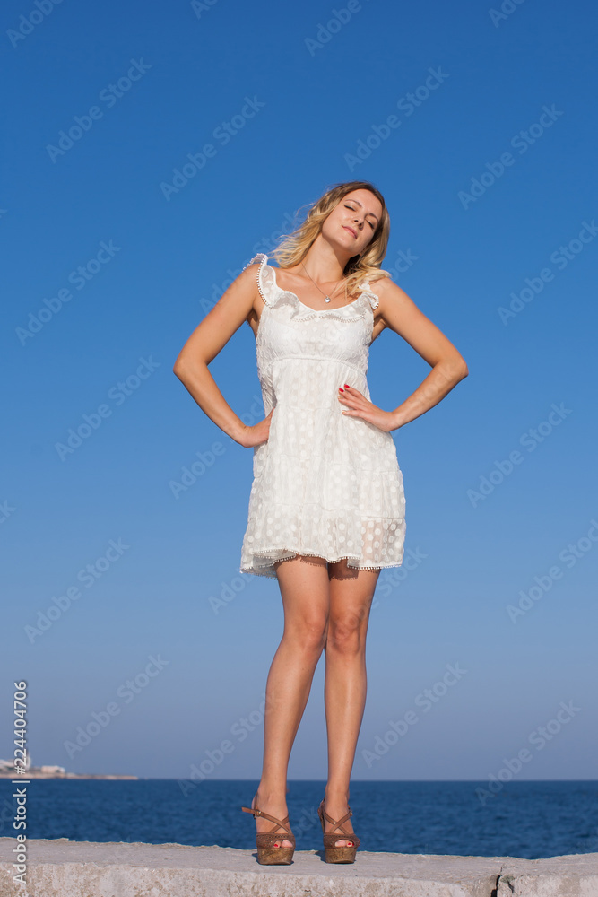Portrait of girl in short white sleeveless dress Portrait of girl in short white sleeveless dress