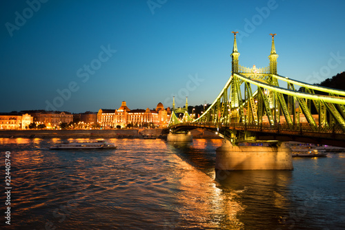 Night river and illuminated Liberty bridge in Budapest photo