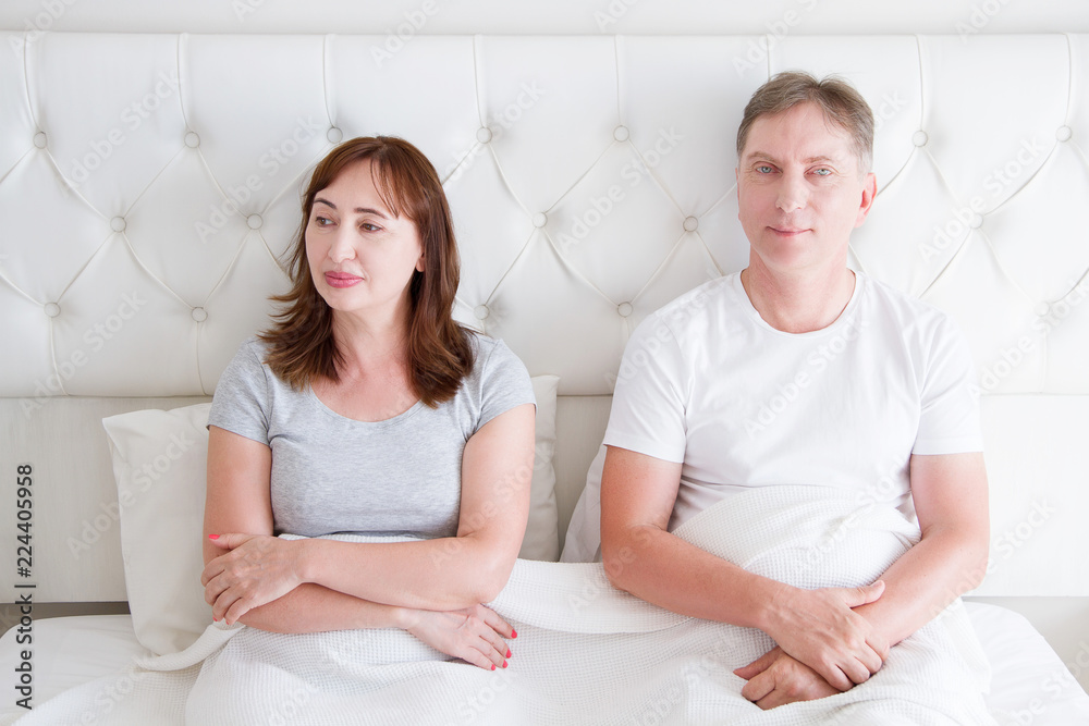 Middle age couple with quarrel problem in relationship in bed. Family life. Copy space. Middle age couple with quarrel problem in relationship in bed. Family life. Copy space.