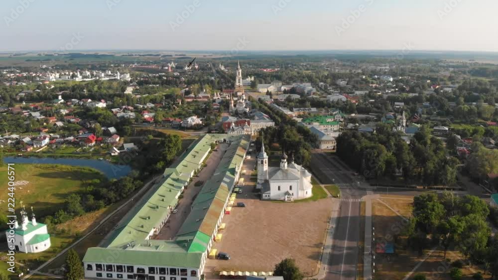 Beautiful panoramic view of Suzdal in summer at sunrise. Resurrection Church on the market square in Suzdal. Suzdal is a famous tourist attraction and part of the Golden Ring of Russia. Beautiful panoramic view of Suzdal in summer at sunrise. Resurrection Church on the market square in Suzdal. Suzdal is a famous tourist attraction and part of the Golden Ring of Russia.