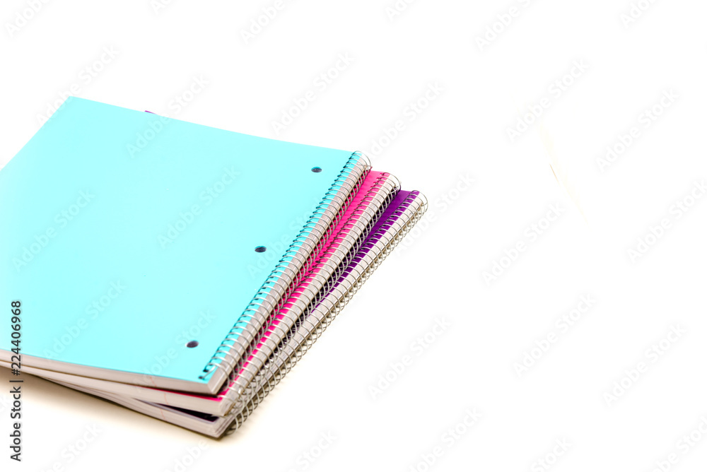 Top view studio shot three 1-subject notebooks isolated on white background. Colorful assortment classroom classic college-ruled notebooks with 3-hole punched to fit standard binder, back to school Top view studio shot three 1-subject notebooks isolated on white background. Colorful assortment classroom classic college-ruled notebooks with 3-hole punched to fit standard binder, back to school