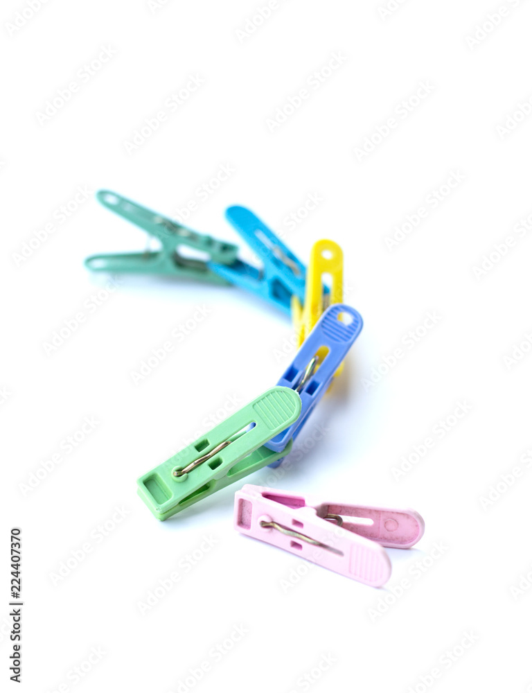 Pile of colorful clothespins isolated on white background