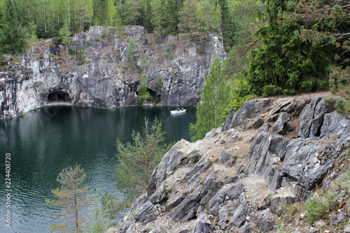 Ruskeala marble quarry, Karelia, Russia. turquoise water in the river and gray with white veins of the shore, forest