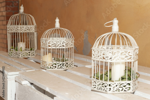 White cages with green grass inside, on white pallet