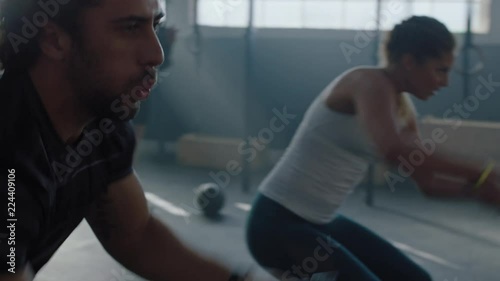 fitness athletes training intense workout using battle ropes team exercise challenge in gym friends high five enjoying healthy bodybuilding lifestyle together