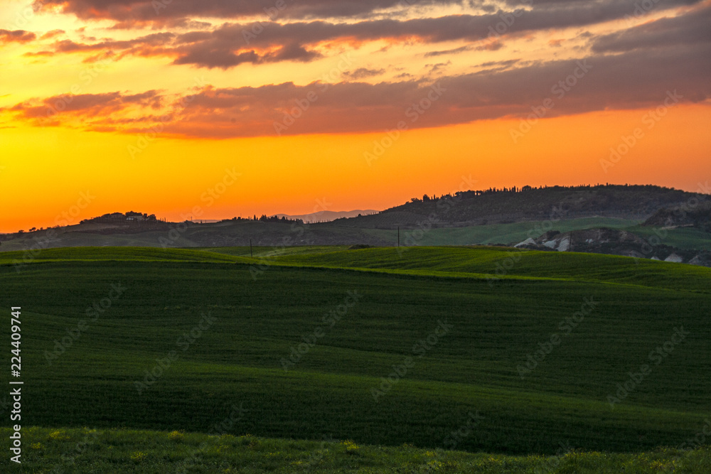 Landscape of tuscan countryside at sunset