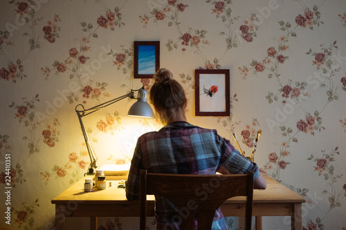A place to work at home. Girl working at home at a wooden table