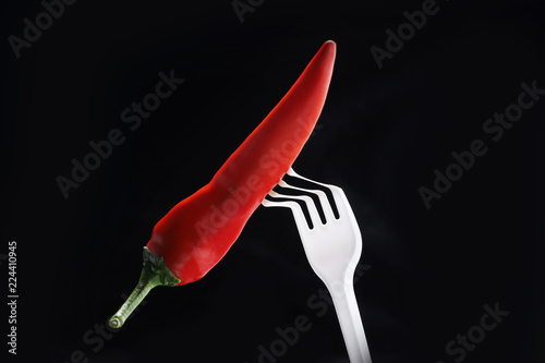 Disposable ware fork burns out. Concept of spicy food.